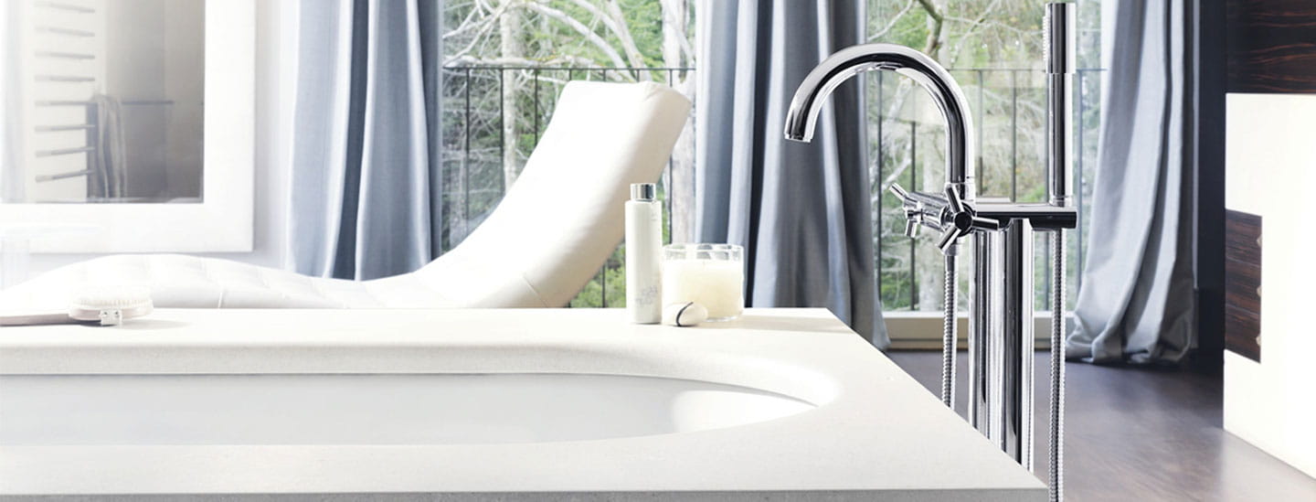 bathtub with floor mounted faucet with chair and open windows in background