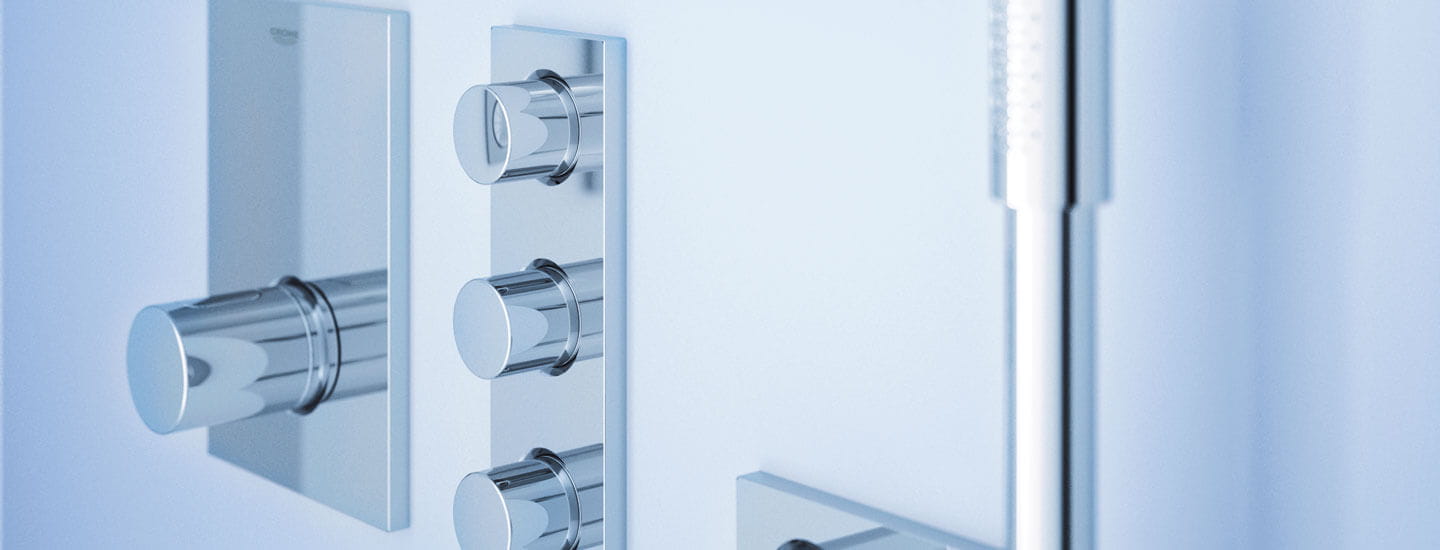 Grohtherm f thermostat knobs in a blue bathroom.