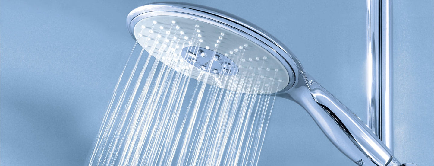 handheld shower with running water and sky blue background