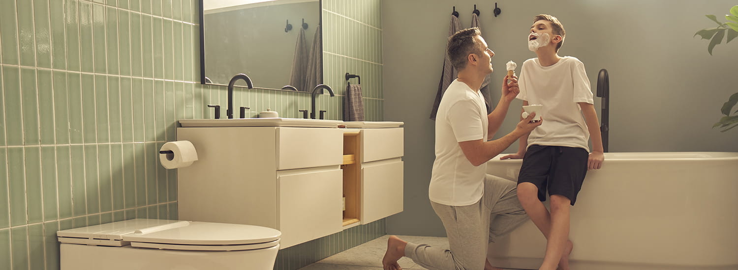 Father and son shaving in Studio S collection bathrooms