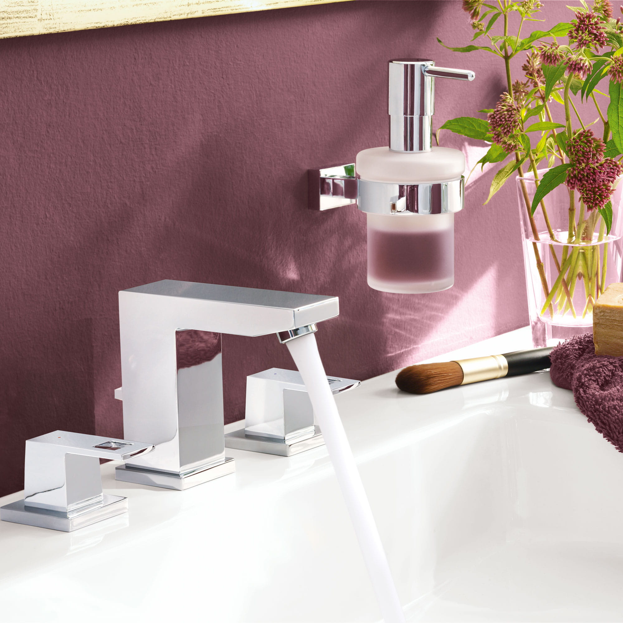 Bathroom faucet in a plum colored room.