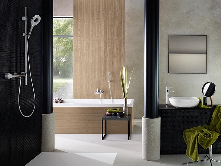 Modern bathroom setting with black tile walls and green accents