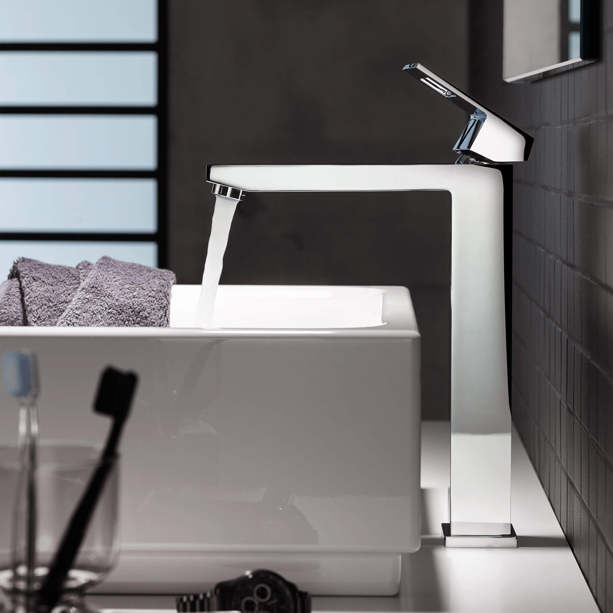 Eurocube faucet spraying water into a white sink.