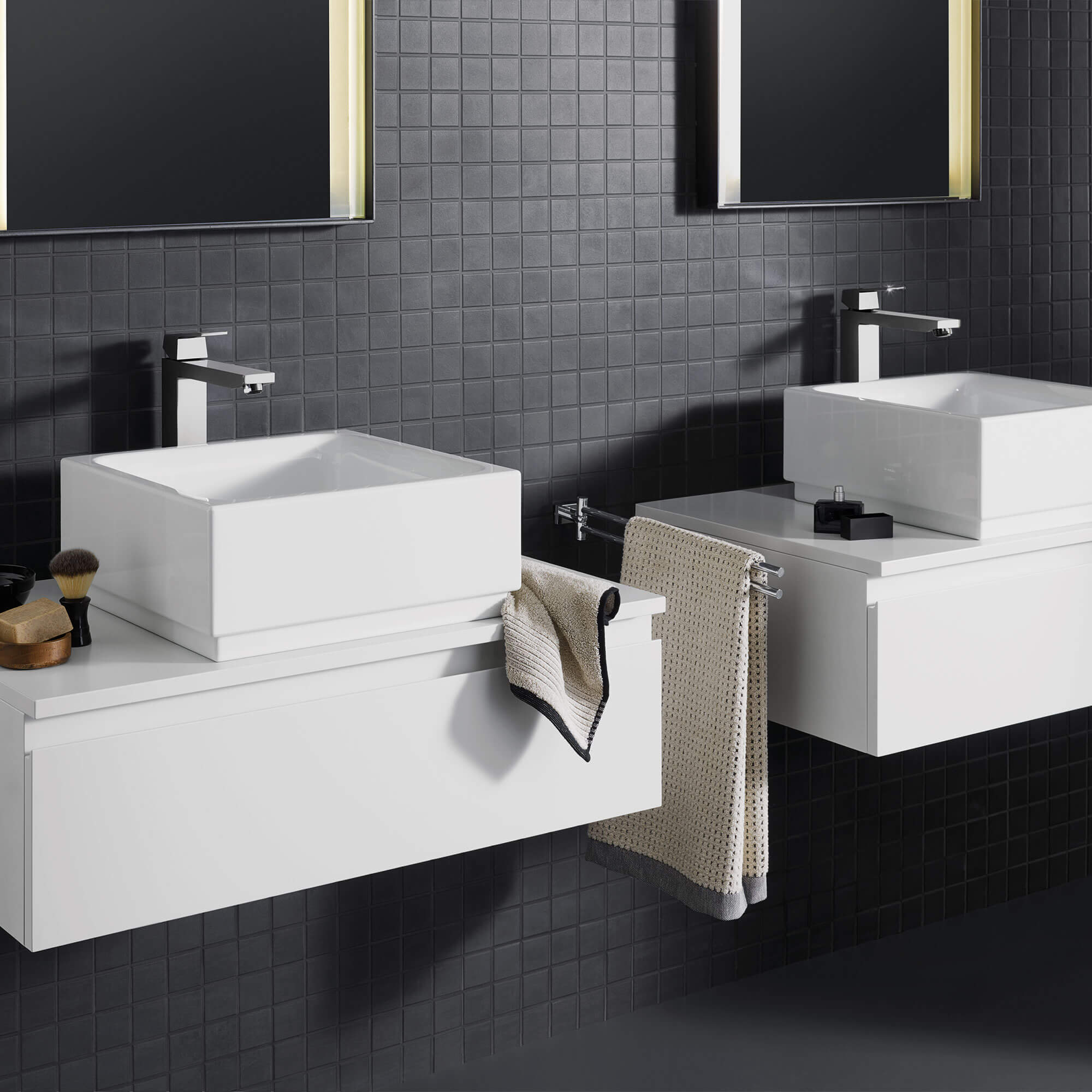 Eurocube faucet in a bathroom with black tiled walls.