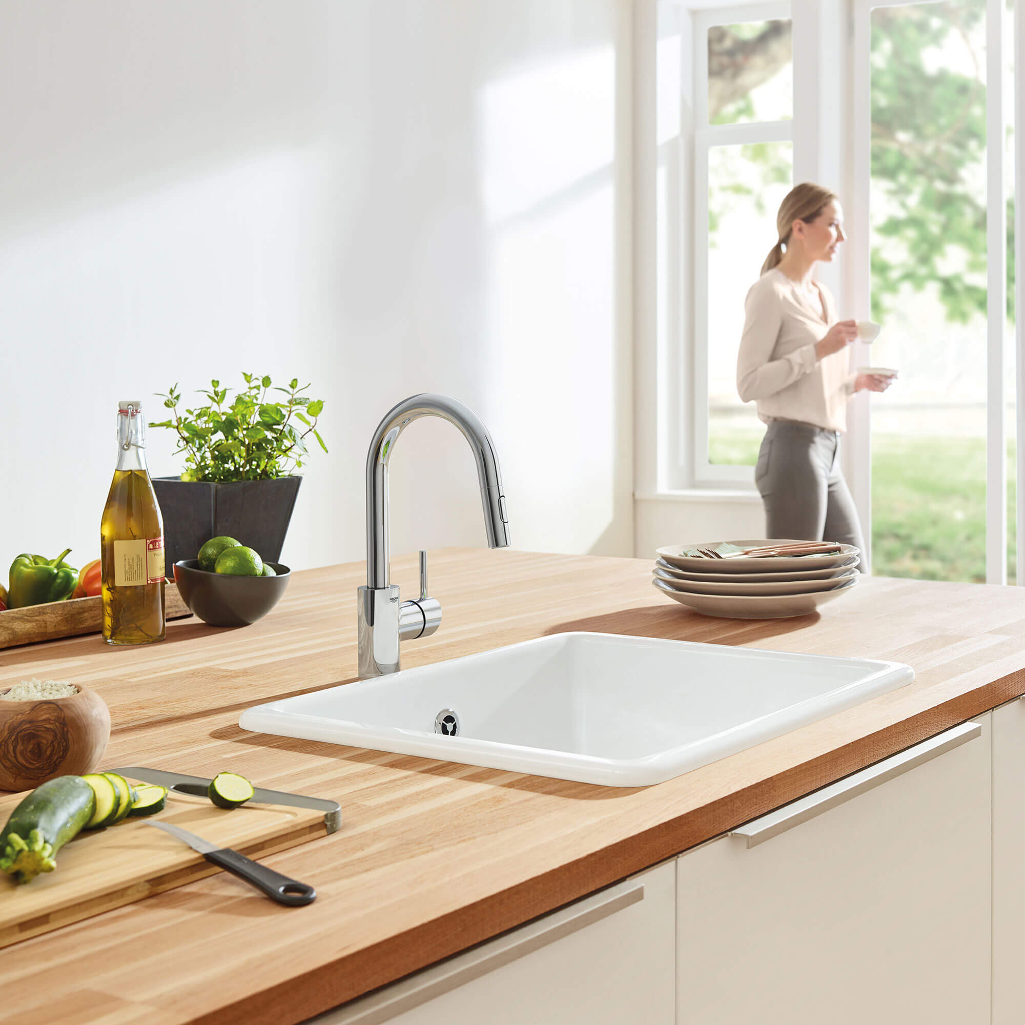 Concetta Kitchen Faucet in Kitchen with Food and a Woman Standing Near a Door