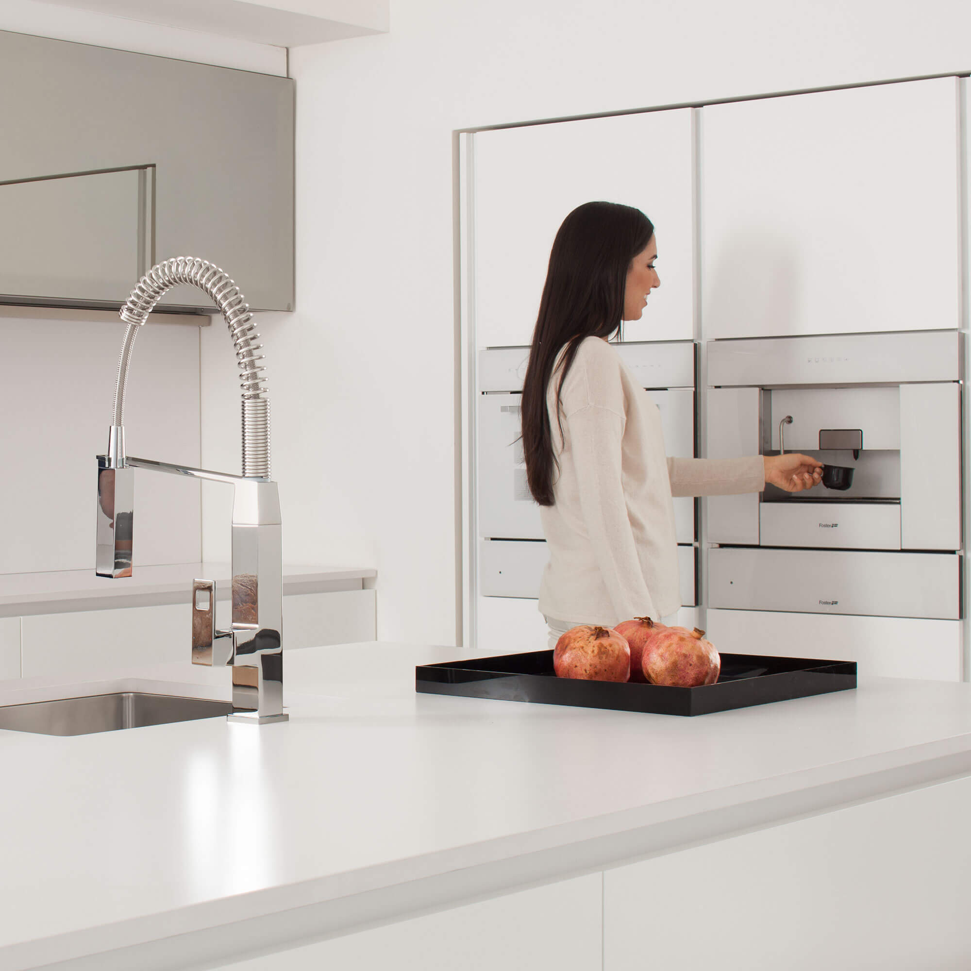 Eurocube kitchen faucet displayed in front of a women. 