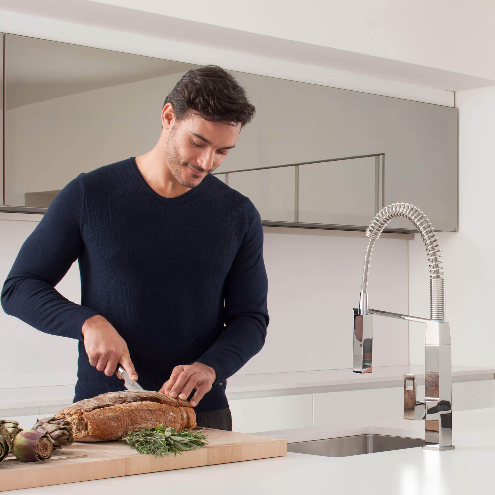 Eurocube kitchen faucet in front of a man slicing bread on cutting board