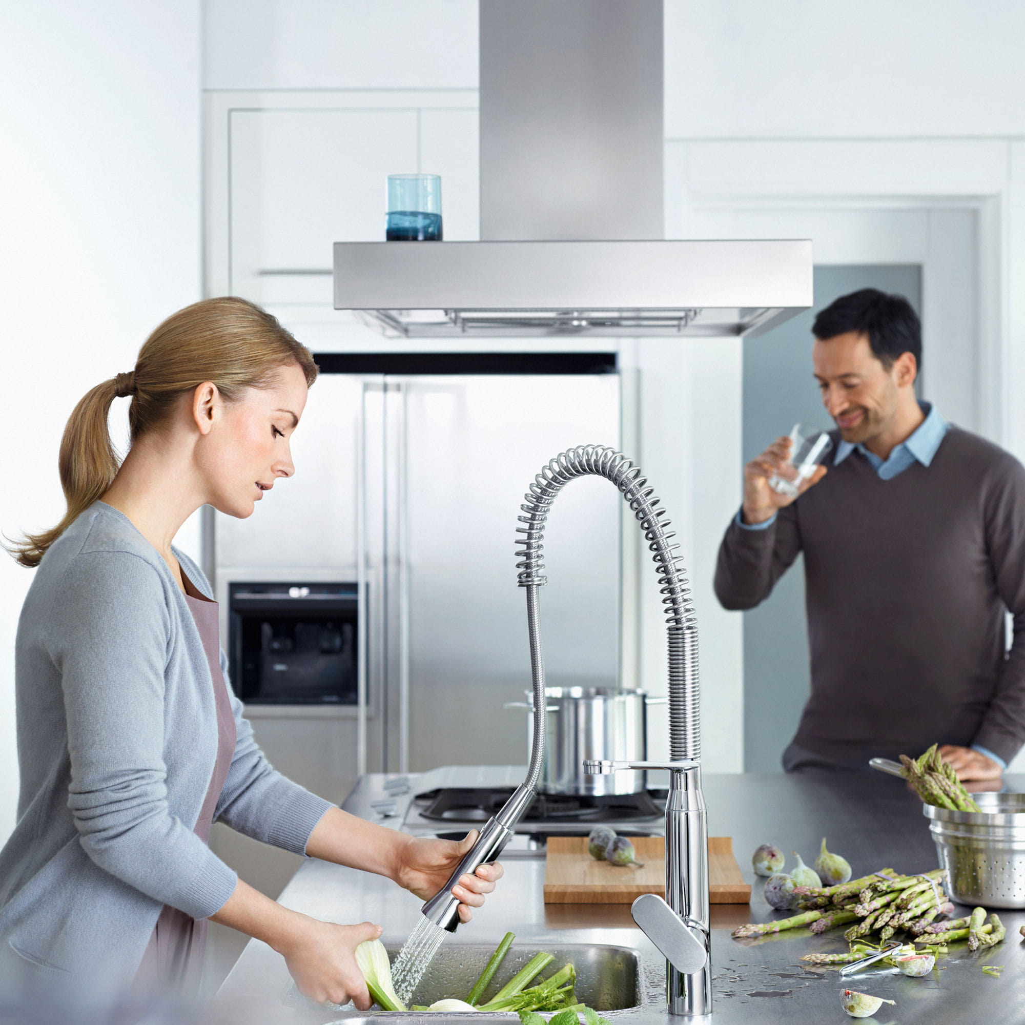 people in kitchen while washing vegetables