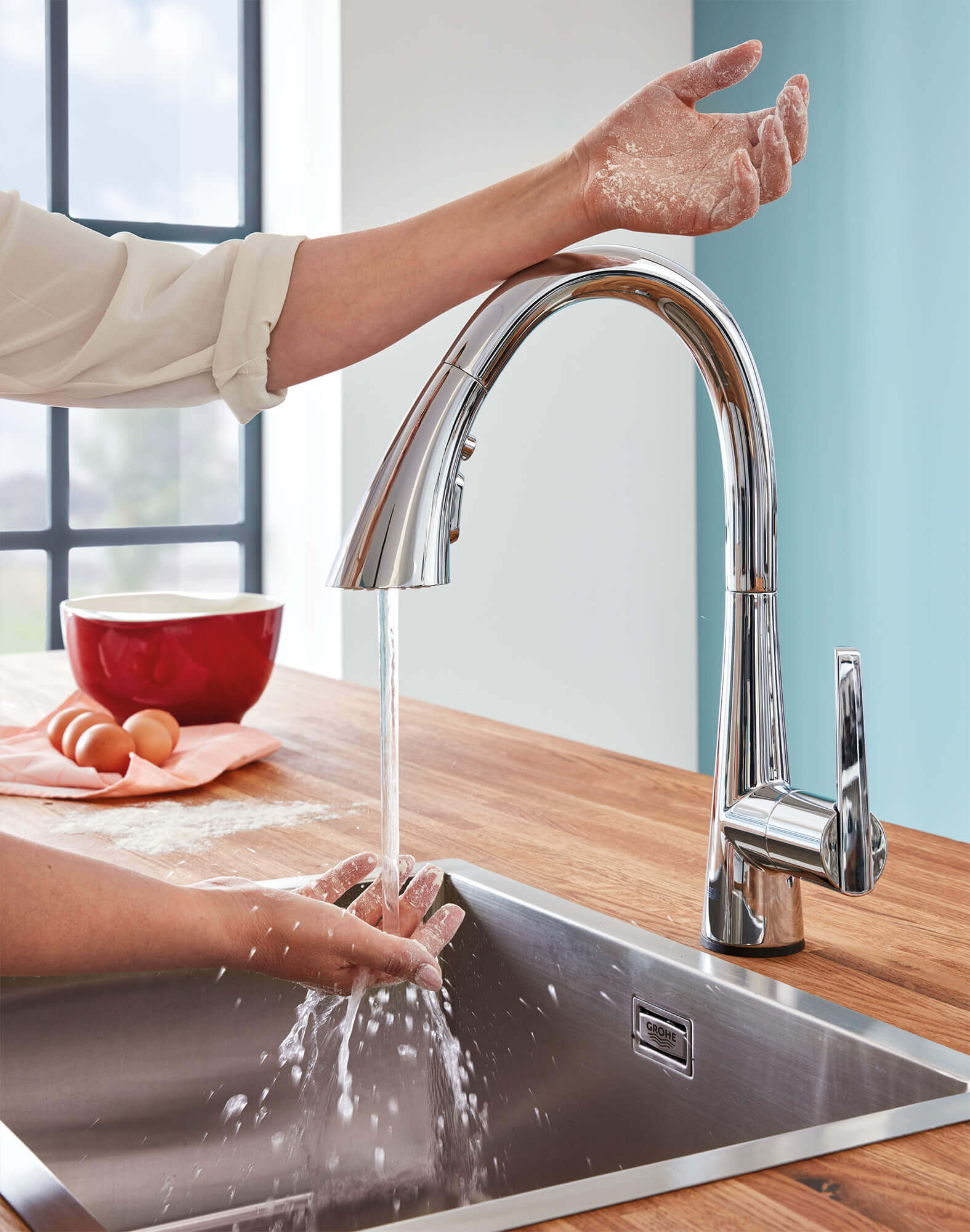 Touch Faucet in use washing hands in the kitchen