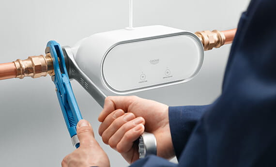 plumber installing Grohe Sense Guard