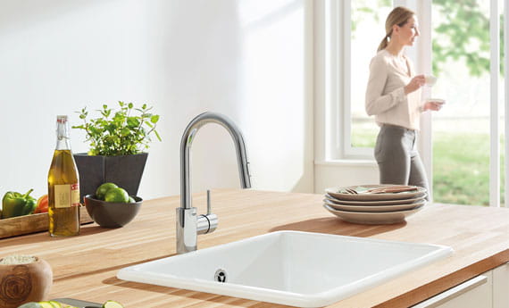 Concetto Single-Handle Kitchen Faucet in Kitchen with Woman Standing near Door