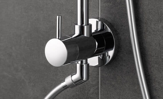 grey scale image of Retro-fit shower handle on the bathroom wall